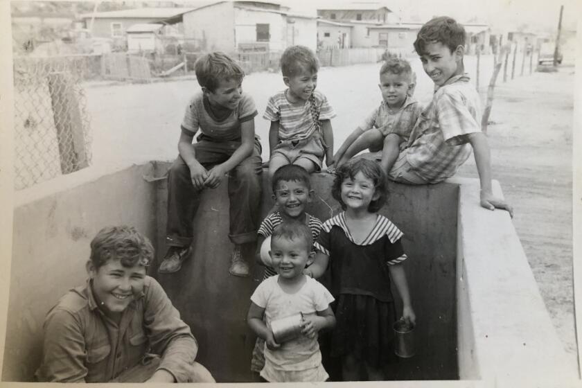 Kids play in an empty water tank in a family photo circa 1959 in Tijuana's neighborhood 20 de Noviembre.