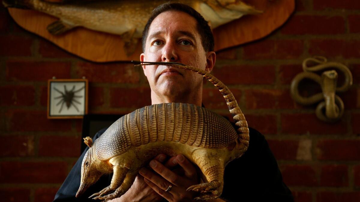 Playwright Tom Jacobson hangs out with some taxidermied critters at home.