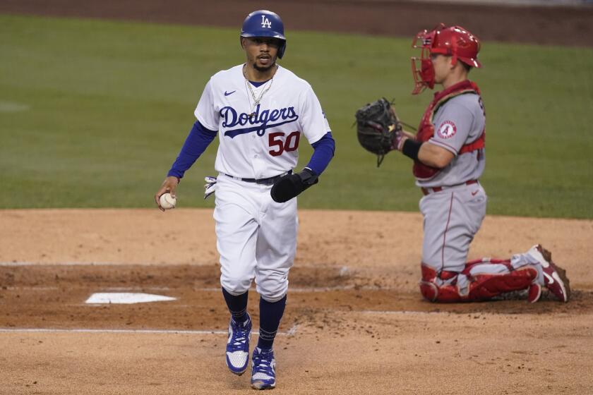 Los Angeles Dodgers' Mookie Betts scores against the Angels during the first inning Sept. 26, 2020.