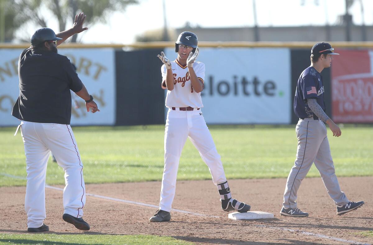 Jack Moyer of Estancia stands on third with a triple during an Orange Coast League opener against Calvary Chapel in 2020.