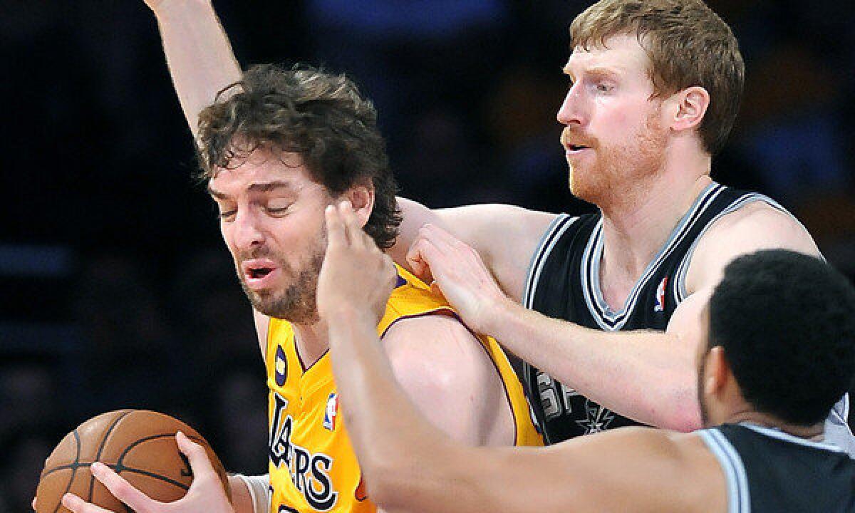 Lakers power forward Pau Gasol is double-teamed by the Spurs' Matt Bonner and Cory Joseph during a playoff game in April. Gasol missed 33 games last season with knee and foot problems.