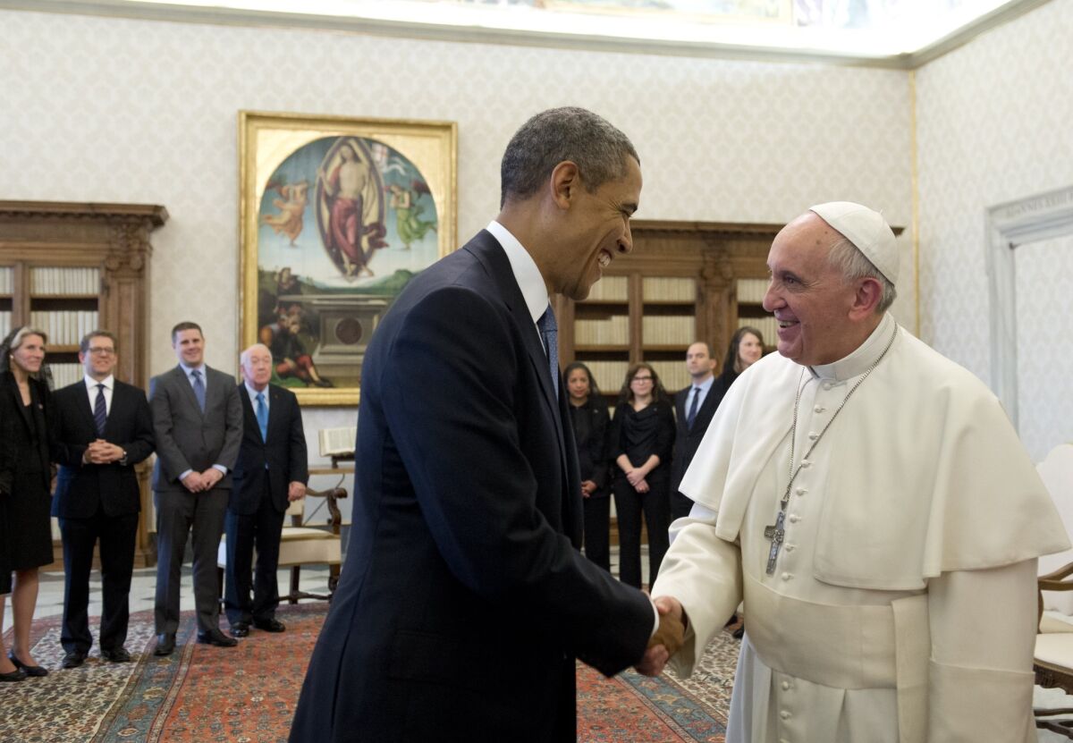 Pope Francis and President Obama shake hands during a private audience on March 27 at the Vatican, where their talks focused in large part on improving U.S.-Cuban relations.