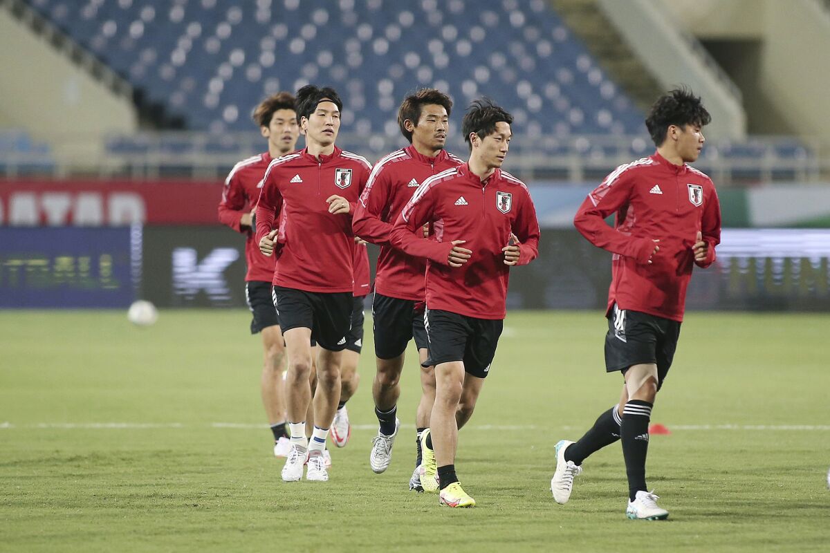 Japan's soccer team trains before the the final round of the 2022 FIFA World Cup Asian Qualifiers match between Vietnam and Japan, at My Dinh stadium in Hanoi, Vietnam, Thursday, Nov. 11, 2021. (AP Photo/Nguyen Van Cuong)