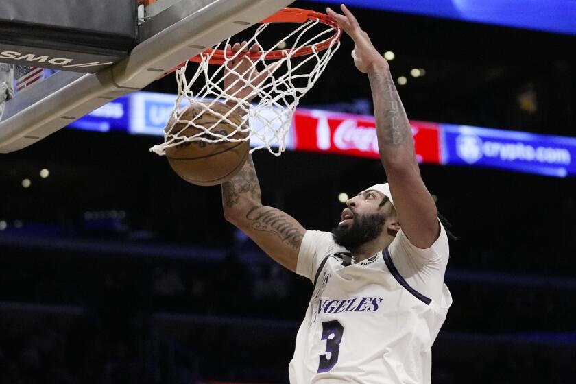 Los Angeles Lakers forward Anthony Davis (3) dunks during the first half of an NBA basketball game.