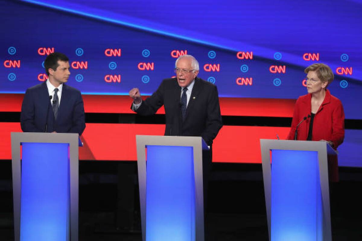 Democratic presidential candidates Sen. Bernie Sanders (I-VT) (C) speaks while Sen. Elizabeth Warren (D-MA) and South Bend, Indiana Mayor Pete Buttigieg (L) listen at the beginning of  the Democratic Presidential Debate in July. A contribution to Sanders has created controversy in California.