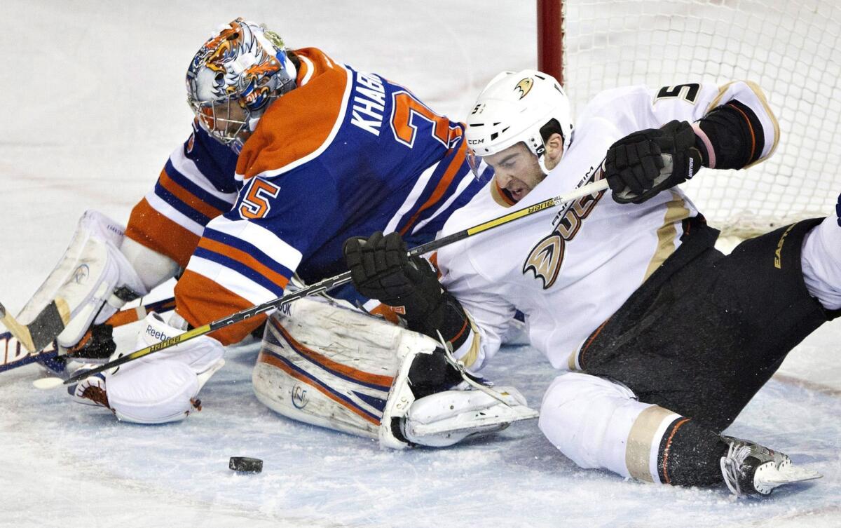 Ducks forward Kyle Palmieri, right, battles with Edmonton Oilers goalie Nikolai Khabibulin for a loose puck during a game in April. Palmieri signed a three-year contract extension Friday.