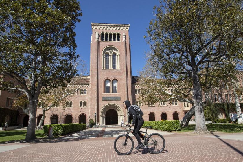 LOS ANGELES, CALIF. -- TUESDAY, MARCH 12, 2019: A view of people visiting the University of Southern California in Los Angeles, Calif., on March 12, 2019. Federal prosecutors say their investigation dubbed Operation Varsity Blues blows the lid off an audacious college admissions fraud scheme aimed at getting the children of the rich and powerful into elite universities. According to prosecutors, wealthy parents paid a firm to help their children cheat on college entrance exams and falsify athletic records of students to enable them to secure admission to schools such as UCLA, USC, Stanford, Yale and Georgetown. Two USC athletic department employees  a high-ranking administrator and a legendary head coach  were fired Tuesday after being indicted in federal court in Massachusetts for their alleged roles in a racketeering conspiracy that helped students get into elite colleges and universities by falsely designating them as recruited athletes. (Allen J. Schaben / Los Angeles Times)