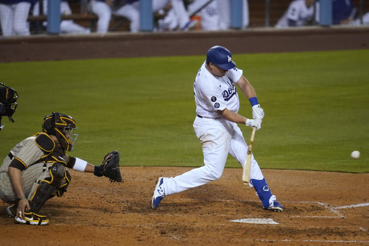 Los Angeles Dodgers' Sheldon Neuse connects for a solo home run during the seventh inning of the team's baseball game.