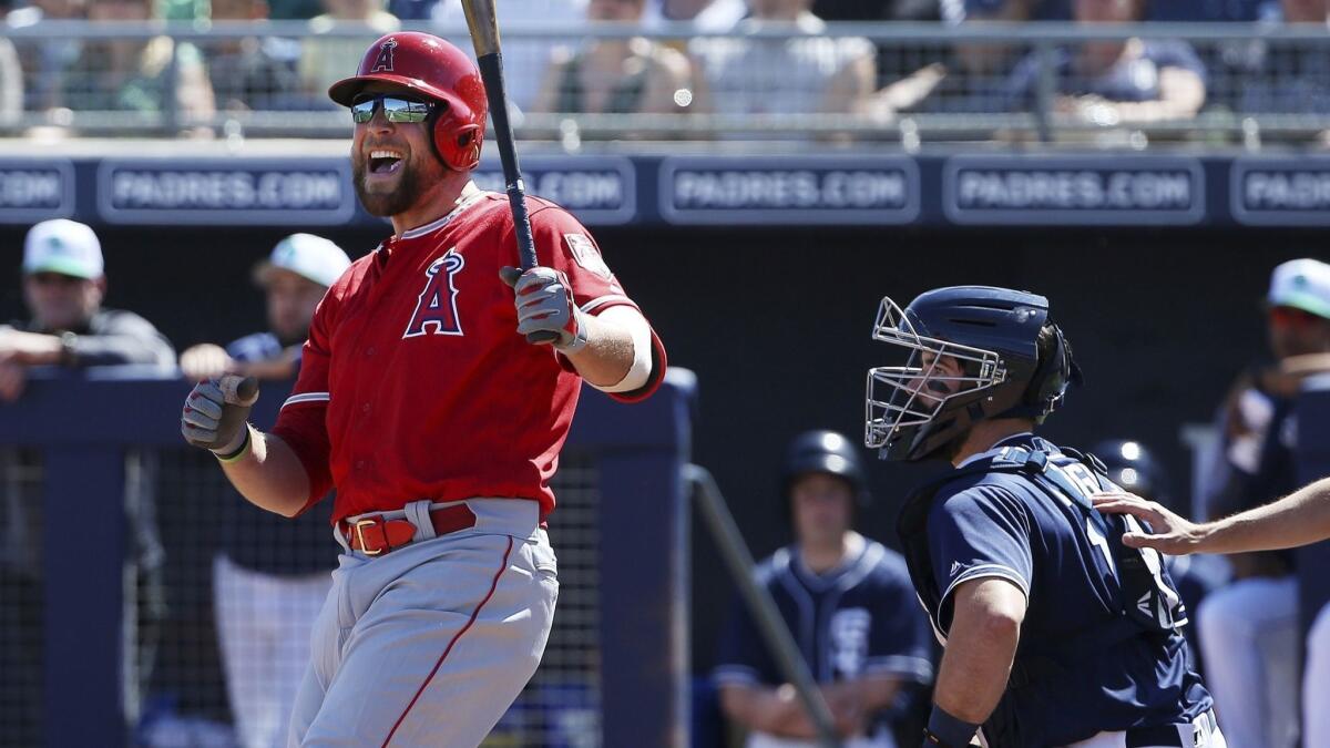 Angels' Kevan Smith, left, shouts as he strikes out as during a spring training game in Peoria, Ariz.