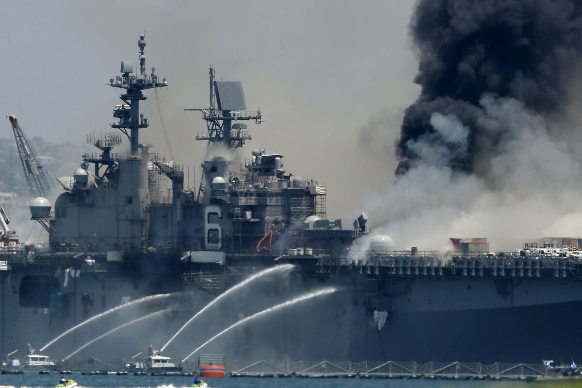 A fire burns on the amphibious assault ship Bonhomme Richard at Naval Base San Diego on July 12, 2020.
