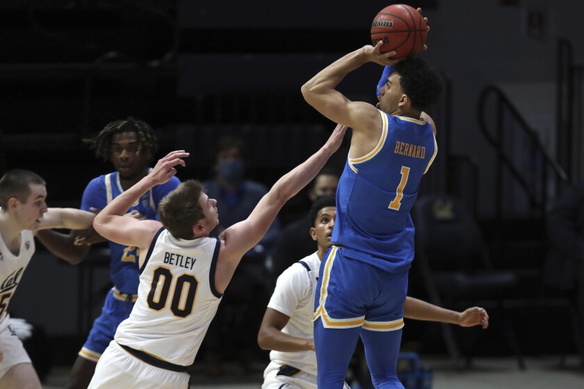 UCLA guard Jules Bernard shoots over California forward Ryan Betley.