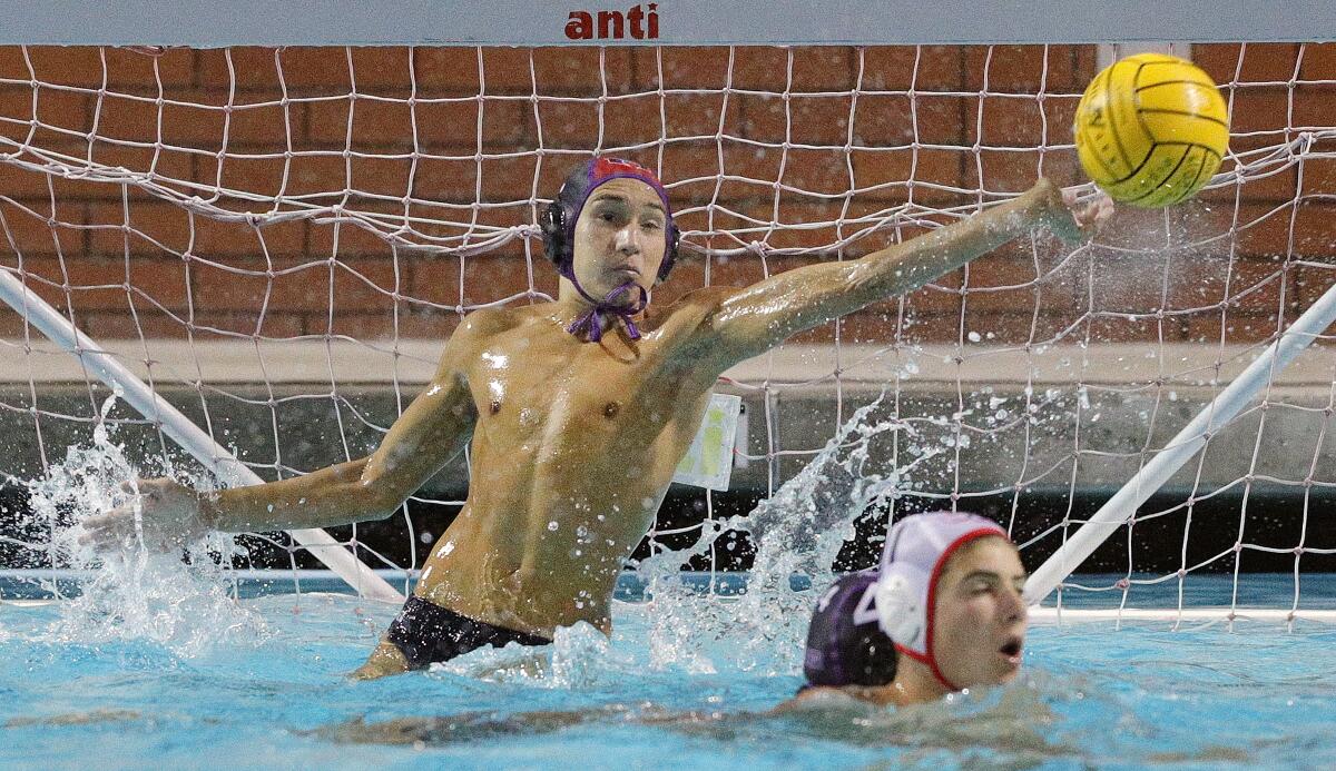Hoover's goalie Oliver Baker reaches out to block a Burroughs shot clear of the goal in the Pacific League preliminary boys' water polo tournament at Arcadia High School on Tuesday, October 29, 2019. Hoover won the game advancing to the finals.