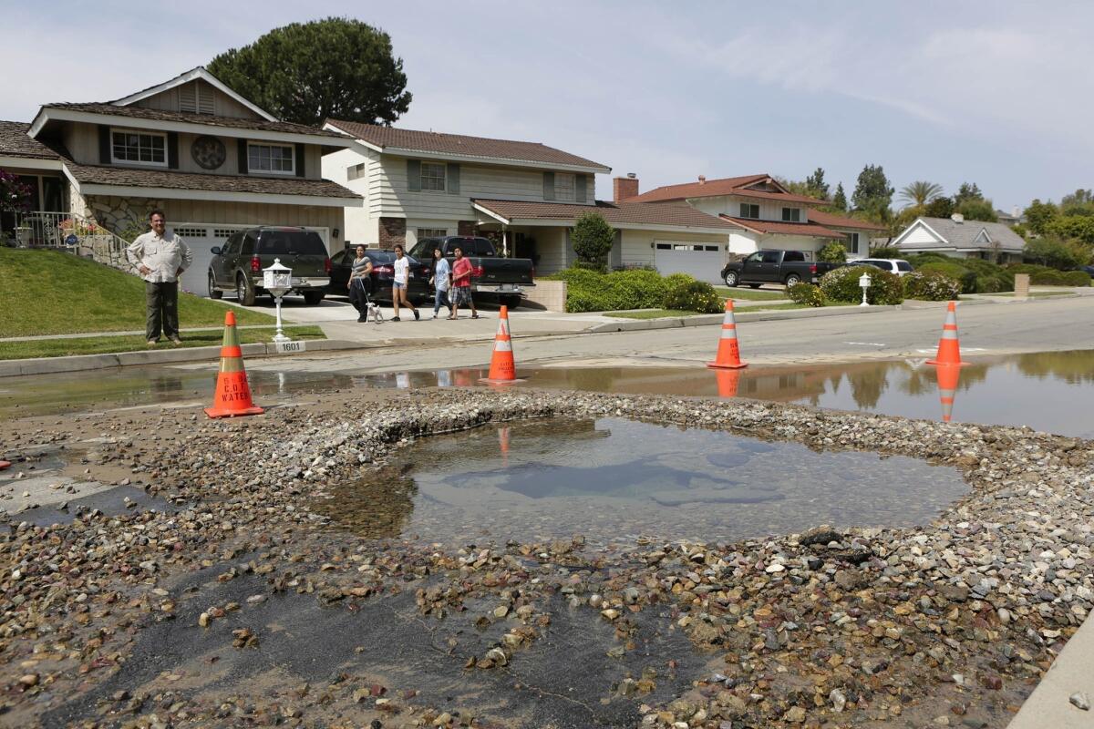 Water flows from a broken pipe on North Canyon Drive in Fullerton after Friday's 5.1 earthquake.