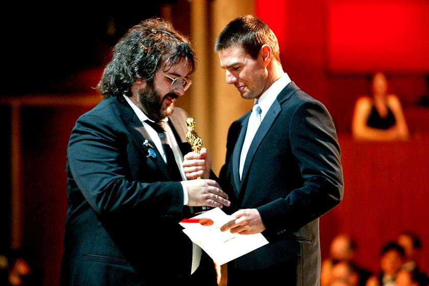 Director Peter Jackson accepts the Best Director award from Tom Cruise at the 76th Academy Awards in 2004.