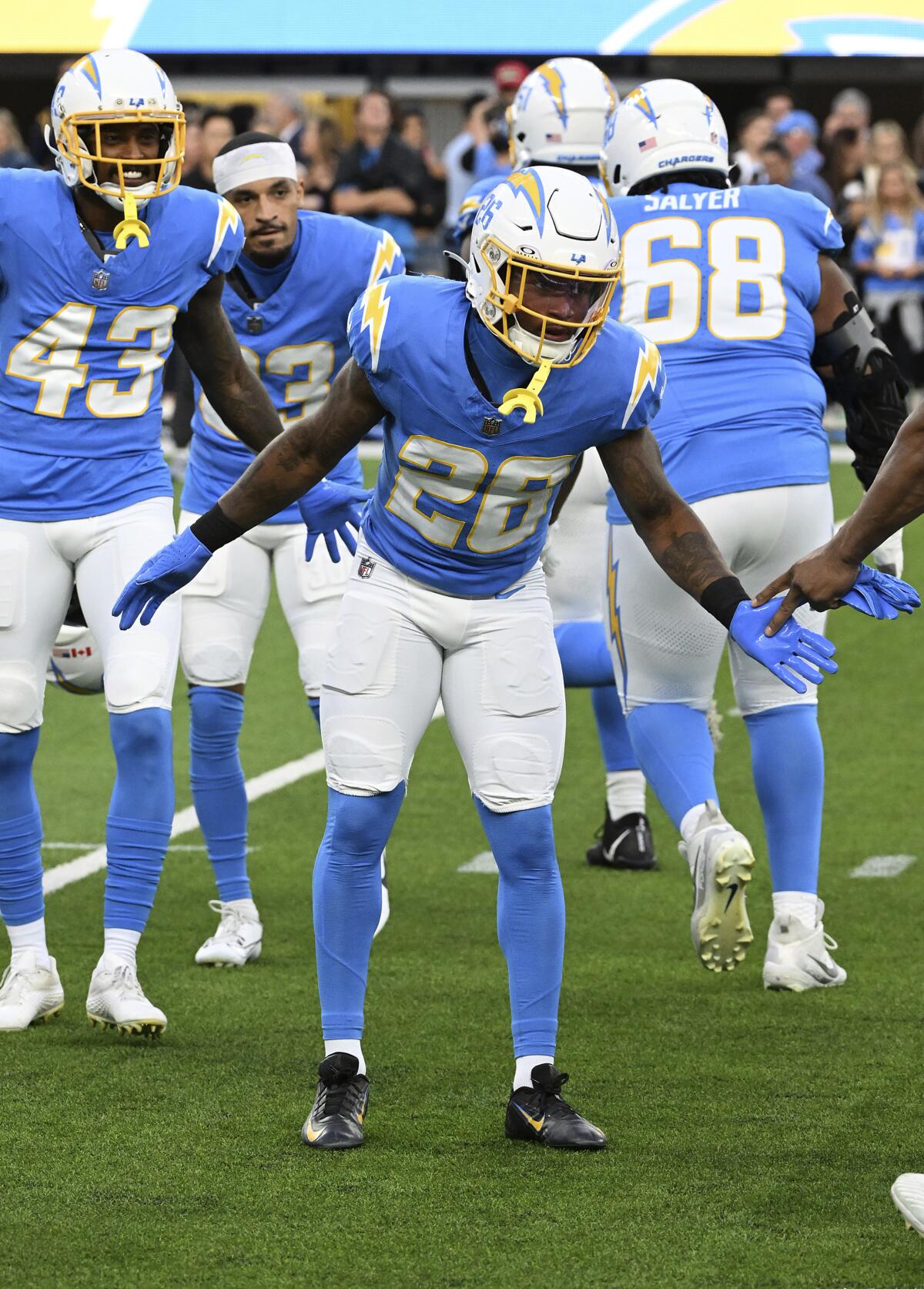 Chargers safety Dean Marlowe greets his teammates as they head onto the field before a game against the Bears