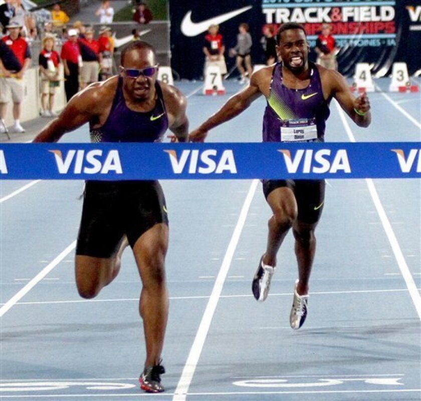 Walter Dix, left, leans into the finish tape to win the 100 meter dash at the USA Outdoor Track and Field Championships, Friday, June 25, 2010, in Des Moines, Iowa. Leroy Dixon, right, finished 6th. (AP Photo/Doug Wells)