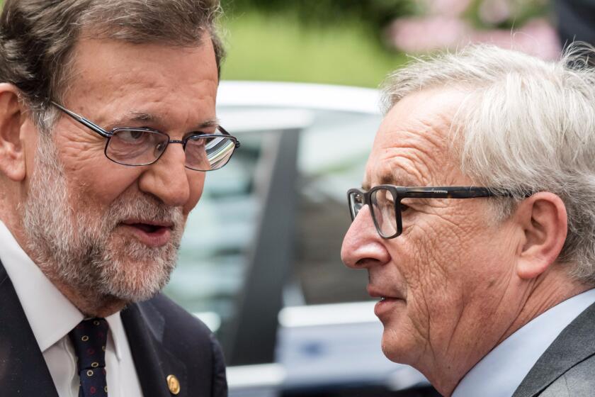 Spanish Prime Minister Mariano Rajoy, left, speaks with European Commission President Jean-Claude Juncker after an EU summit in Brussels on Wednesday, June 29, 2016.