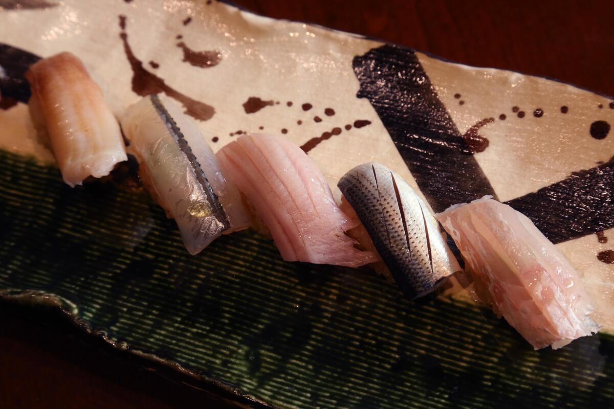 The varieties of sushi offered at Shiki include, from left, mirugai, sayori, buri, kohada and tai kobujime sea bream.