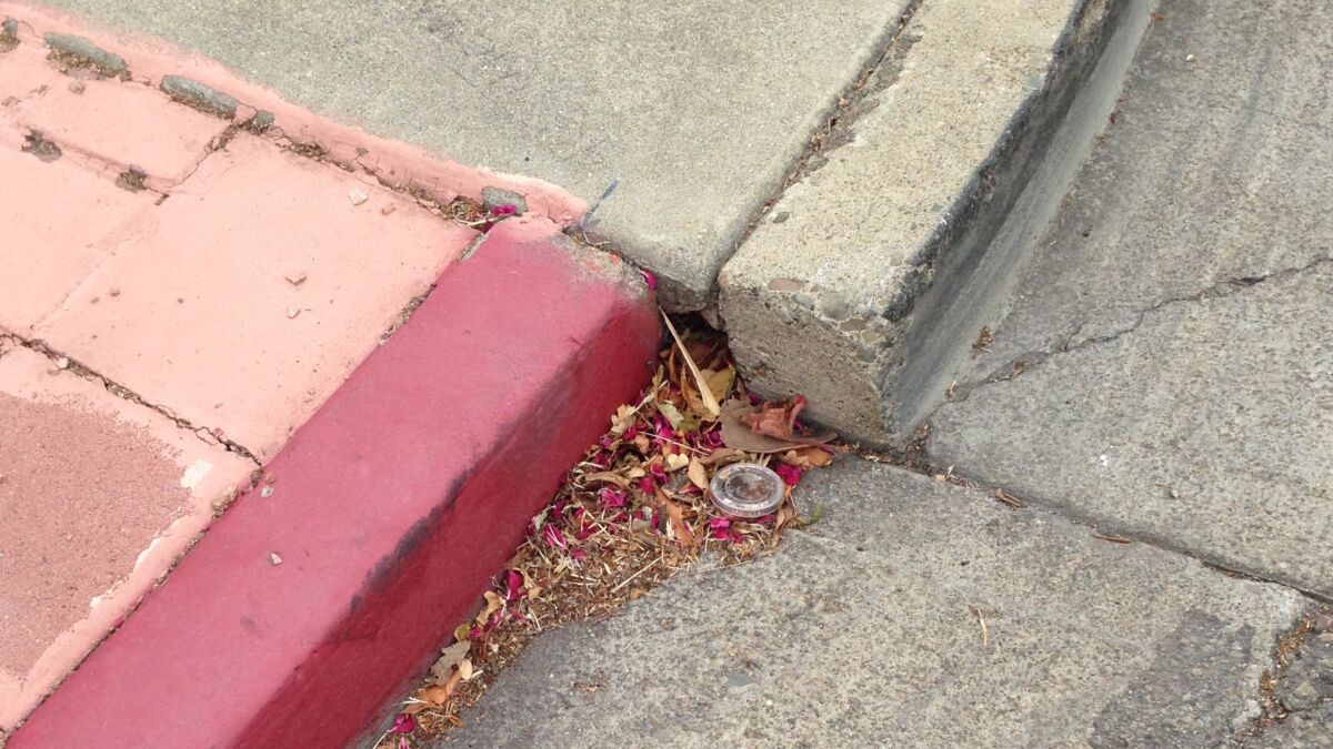 This curb was once flush but became offset because the Hayward fault is pulling the curb apart. (Rong-Gong Lin II / Los Angeles Times)