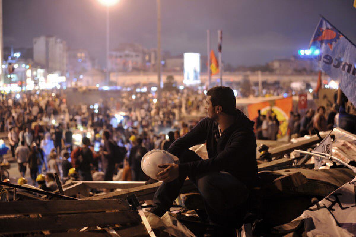 An antigovernment protester looks toward Taksim Square from Gezi Park in Istanbul, Turkey.