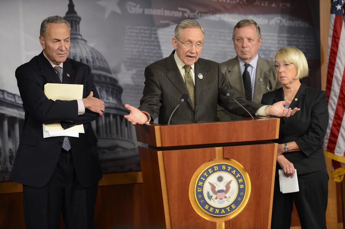 Senate Majority Leader Harry Reid (D-Nev.) second from left, with fellow Democratic Sens. Charles Schumer of New York, Dick Durbin of Illinois and Patty Murray of Washington, responds to a question about the partial government shutdown during a news conference Friday in the Capitol.