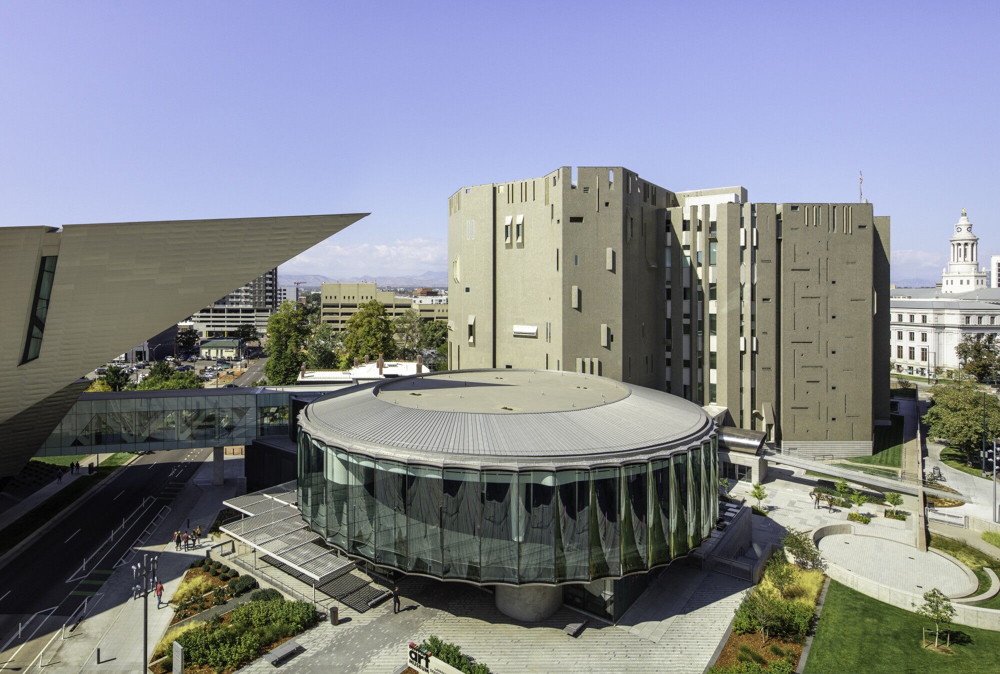 The Denver Art Museum campus from above shows a pointed titanium building, an oval pavilion and a castle-like tower