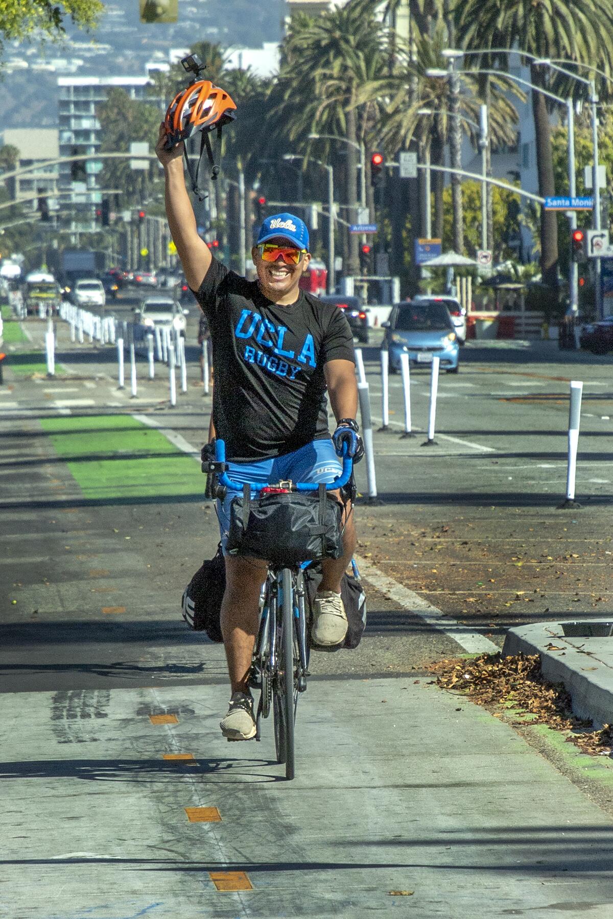 An exuberant Juan Pablo Garces Ramirez pedals down Santa Monica's Ocean Avenue 