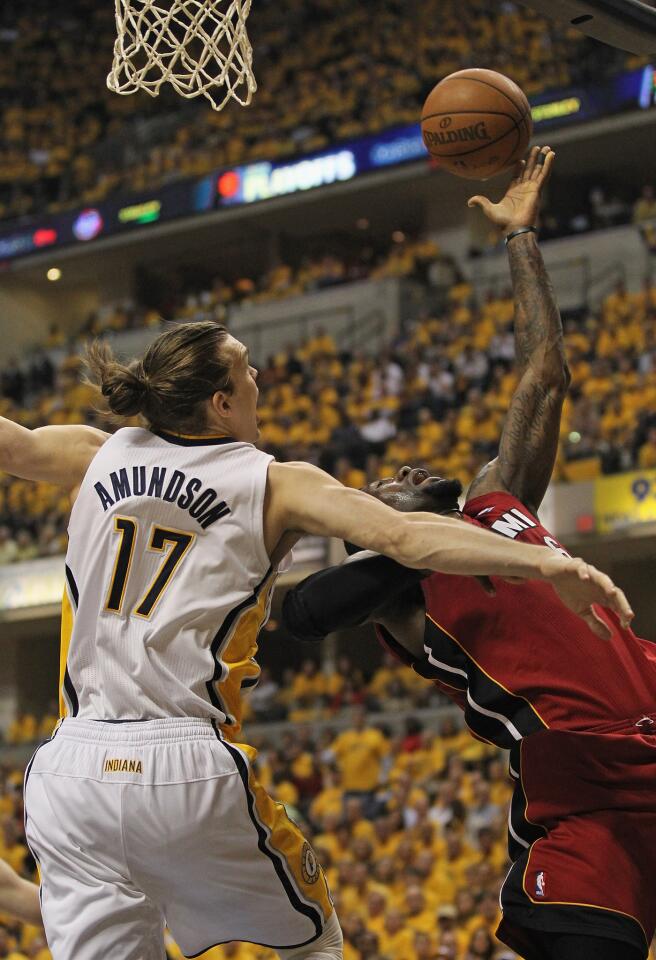 INDIANAPOLIS, IN - MAY 17: LeBron James #6 of the Miami Heat tries to get off a shot against Lou Amundson #17 of the Indiana Pacers in Game Three of the Eastern Conference Semifinals in the 2012 NBA Playoffs at Bankers Life Fieldhouse on May 17, 2012 in Indianapolis, Indiana. NOTE TO USER: User expressly acknowledges and agrees that, by downloading and/or using this photograph, User is consenting to the terms and conditions of the Getty Images License Agreement. (Photo by Jonathan Daniel/Getty Images) ORG XMIT: 144567469