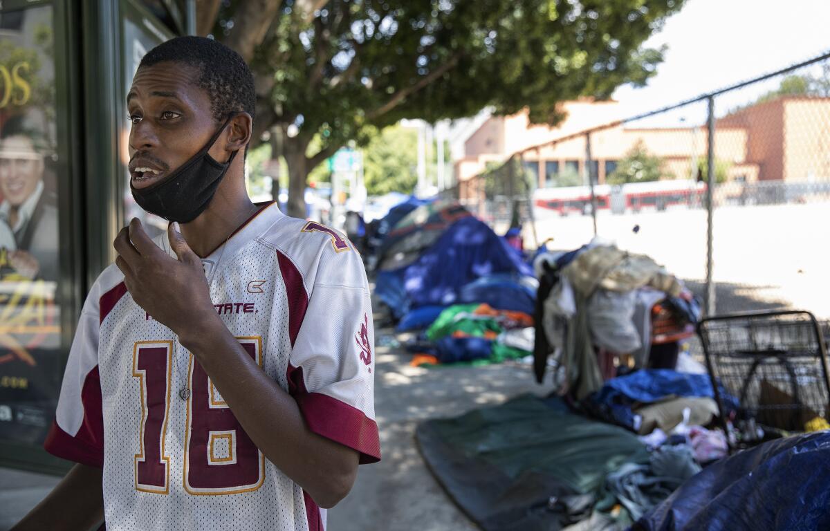 Karl Hamilton stands outside his tent in downtown Los Angeles 