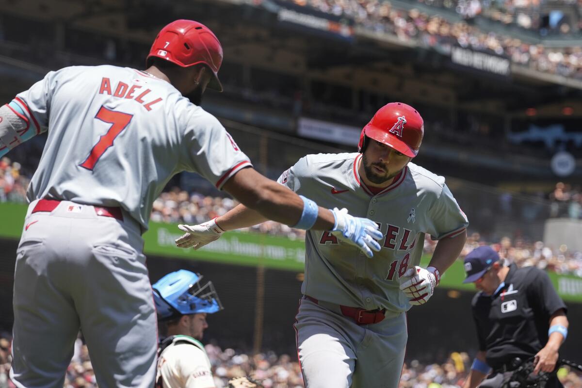 Nolan Schanuel, right, celebrates with Angels teammate Jo Adell after hitting a solo home run Sunday against the Giants.