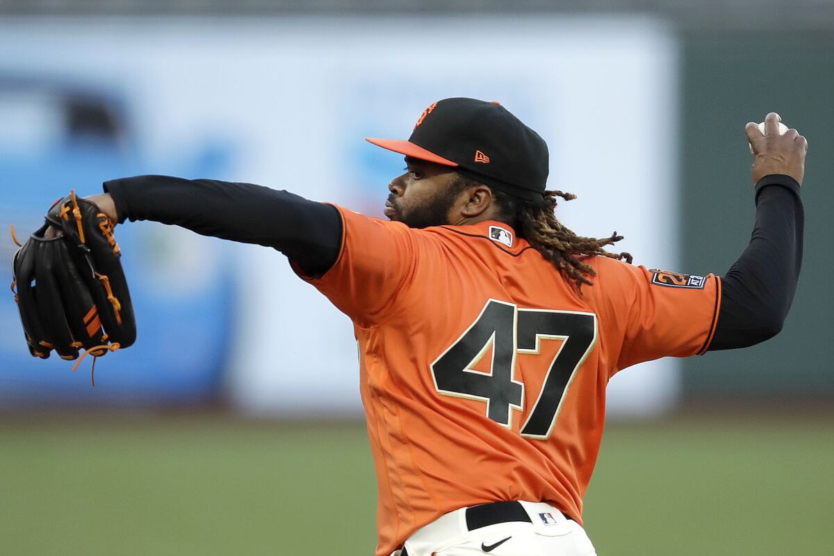 San Francisco Giants pitcher Johnny Cueto works against the Oakland Athletics in the first inning of a baseball game Friday, Aug. 14, 2020, in San Francisco. (AP Photo/Ben Margot)