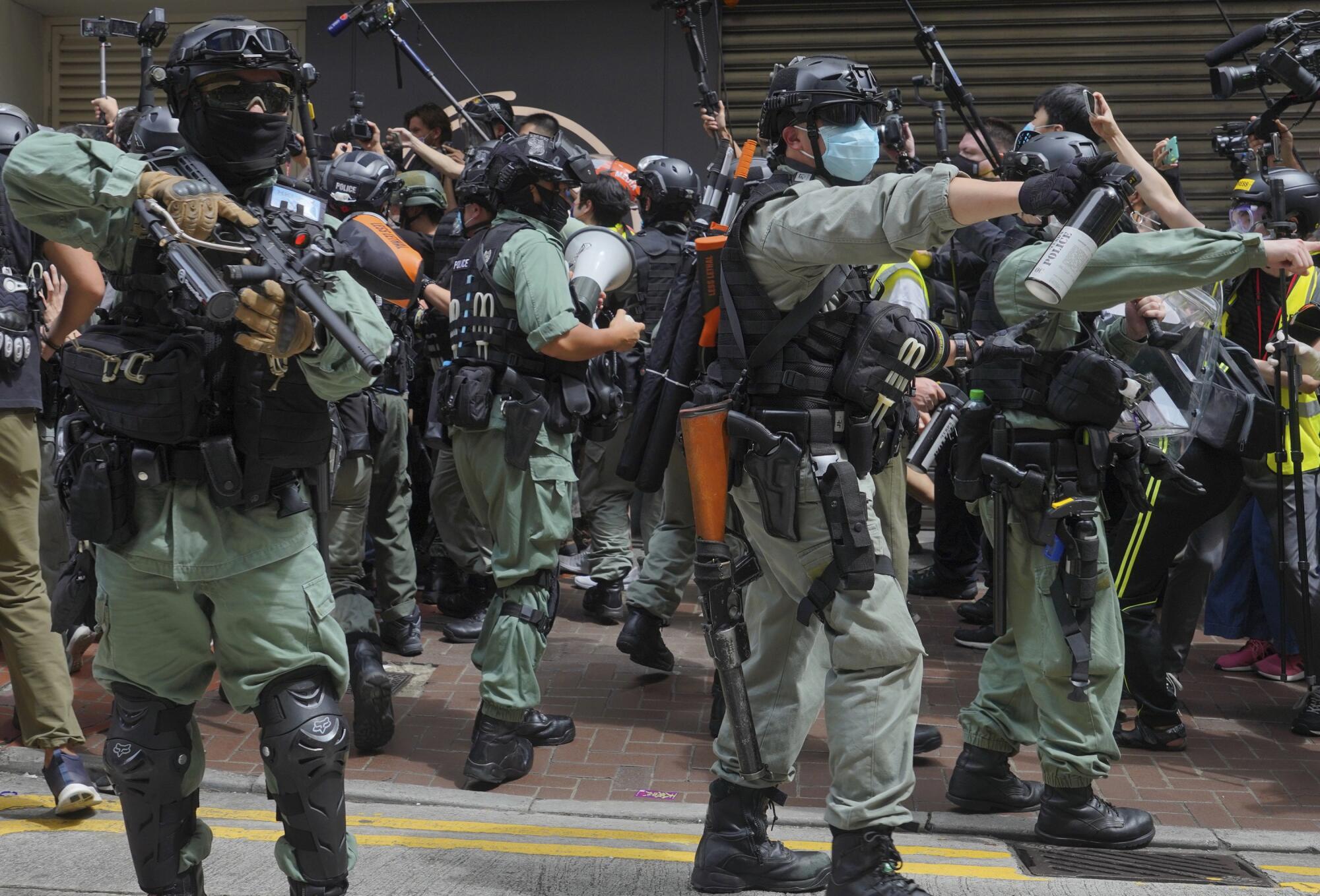 Police pepper spray protesters in Causeway Bay during the annual handover march in Hong Kong on Wednesday.