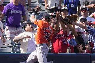 Houston Astros left fielder Trey Cabbage initially makes a catch on a ball hit by Los Angeles Angels.