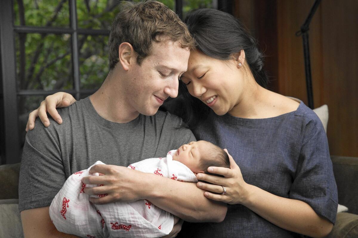 Facebook CEO Mark Zuckerberg and his wife, Priscilla Chan, hold their newborn daughter, Max Chan Zuckerberg, in an undated photo.