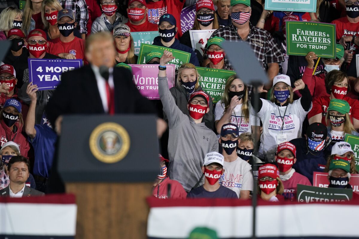 Supporters behind President Trump react as he speaks at a campaign rally in Des Moines, Iowa, on Wednesday.