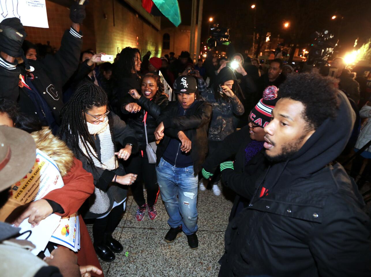 Protesters and activists celebrate outside Chicago police headquarters, on South Michigan Avenue at 35th Street, on Dec. 1, 2015, hours after Chicago Mayor Rahm Emanuel asked for and accepted the resignation of police Superintendent Garry McCarthy.