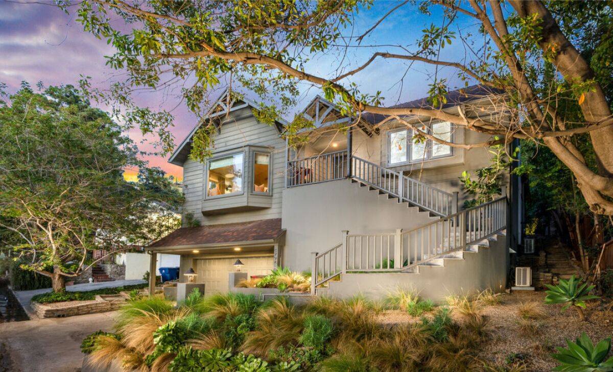 The Craftsman-style home sits on a steep hillside lot.