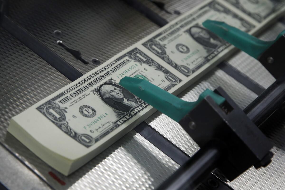 $1 bills are cut and stacked at the Bureau of Engraving and Printing in Washington