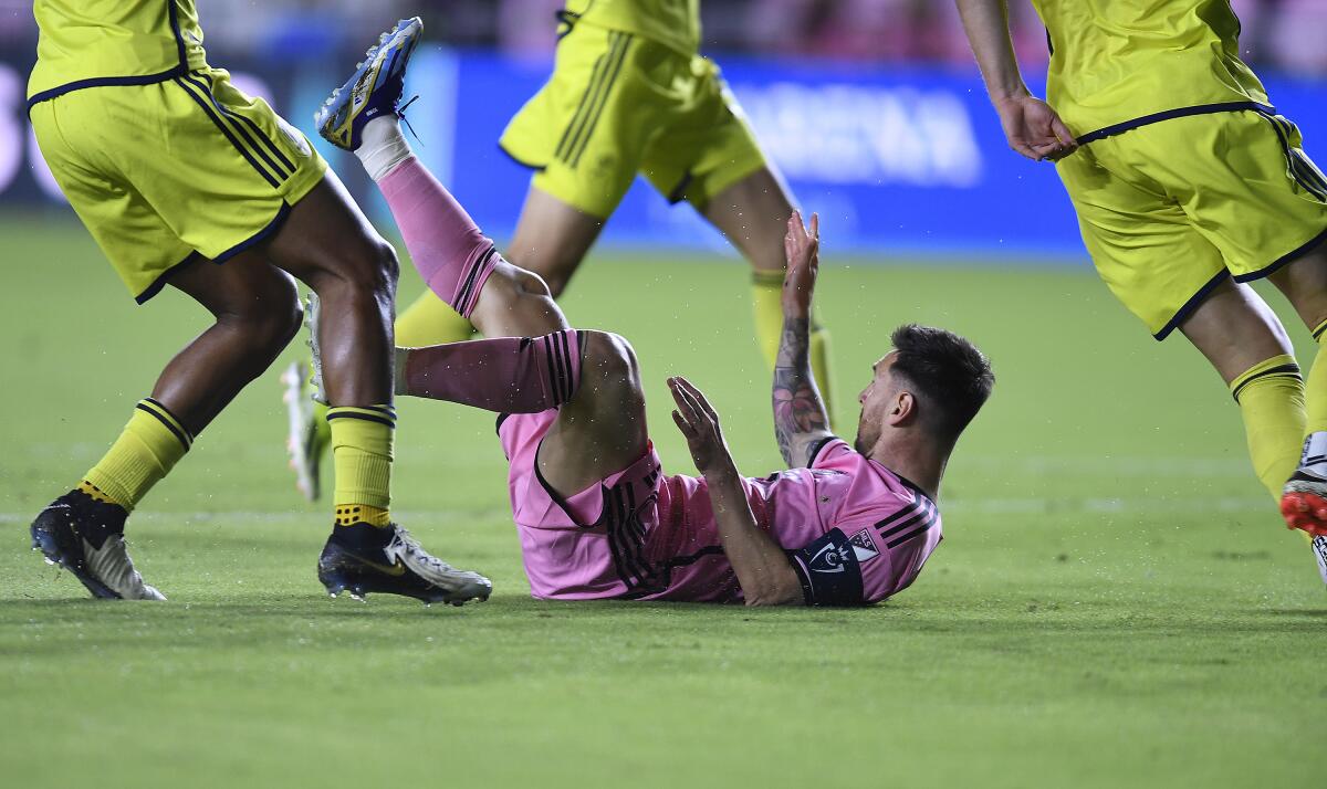 Inter Miami forward Lionel Messi is tripped by the Nashville SC defe 