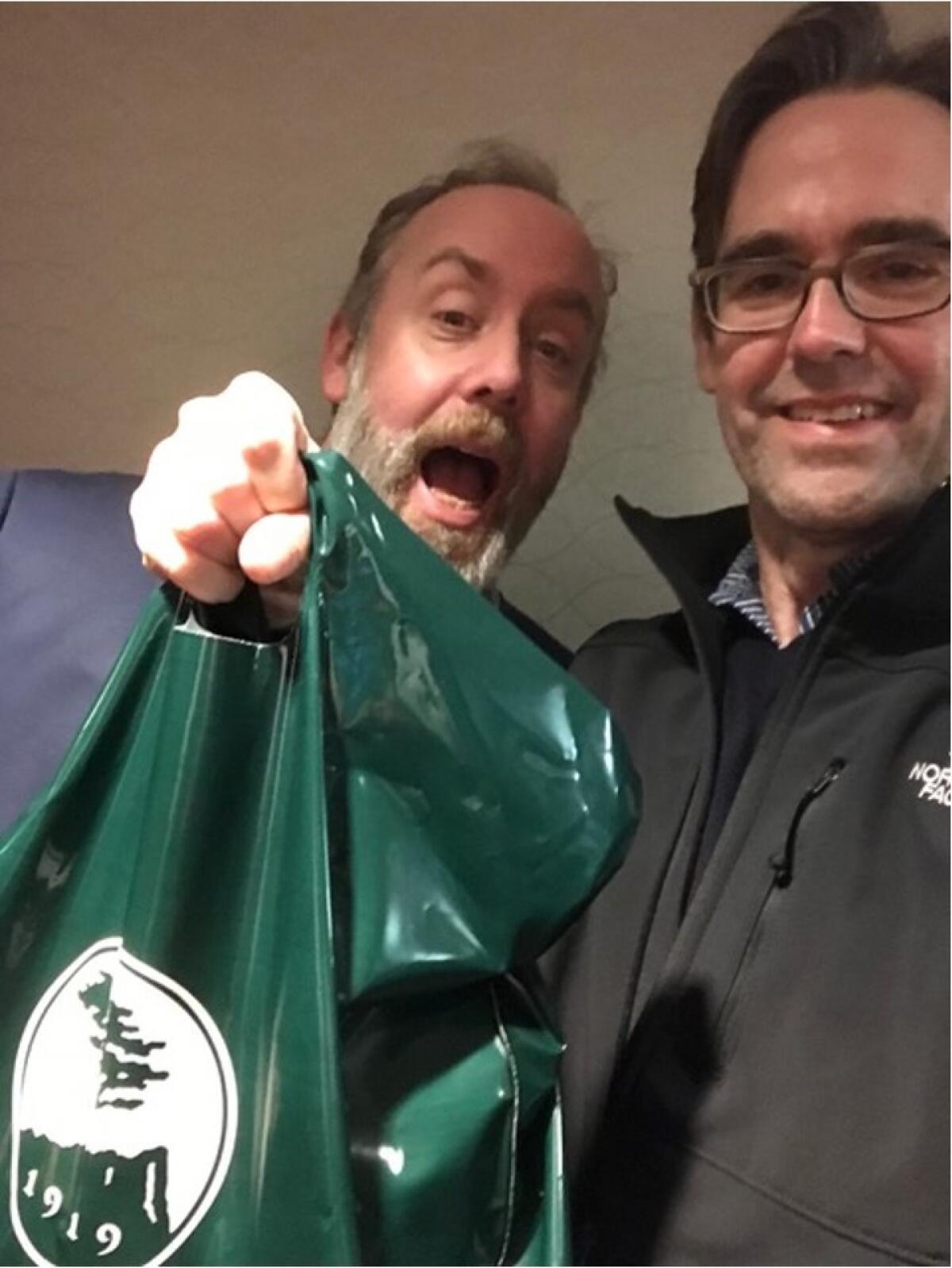 Hayes, right, and Scott Jackson holding the first bag of their father's remains pre-Pebble trip.