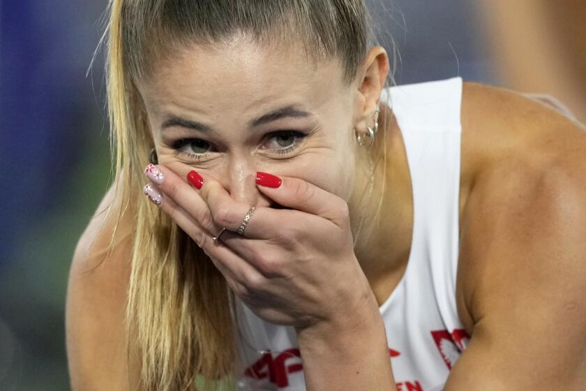 Natalia Kaczmarek, of Poland, reacts after winning the gold medal in the women's 400 meters final at the European Athletics Championships in Rome, Monday, June 10, 2024. (AP Photo/Alessandra Tarantino)