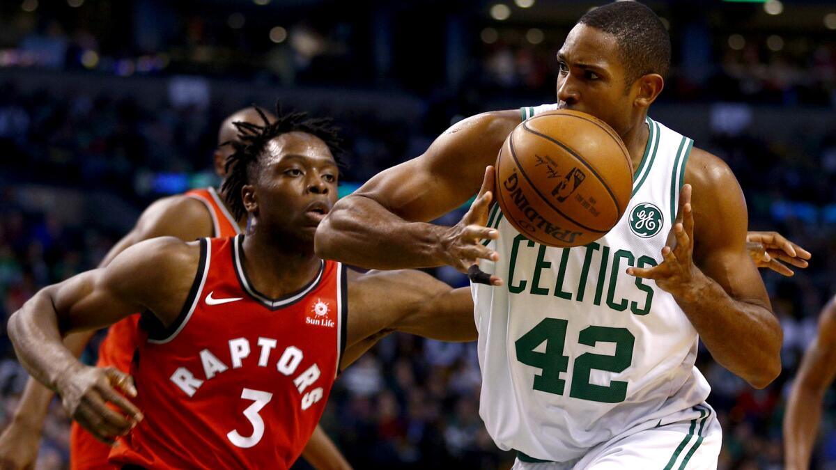 Celtics forward Al Horford tries to retain possession of the ball as he drive against Raptors forward OG Anunoby during the second half on Sunday.