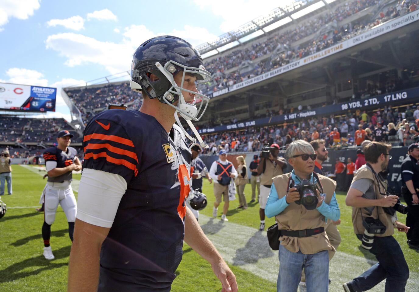 Jay Cutler walks off the field after his team's loss to the Green Bay Packers.