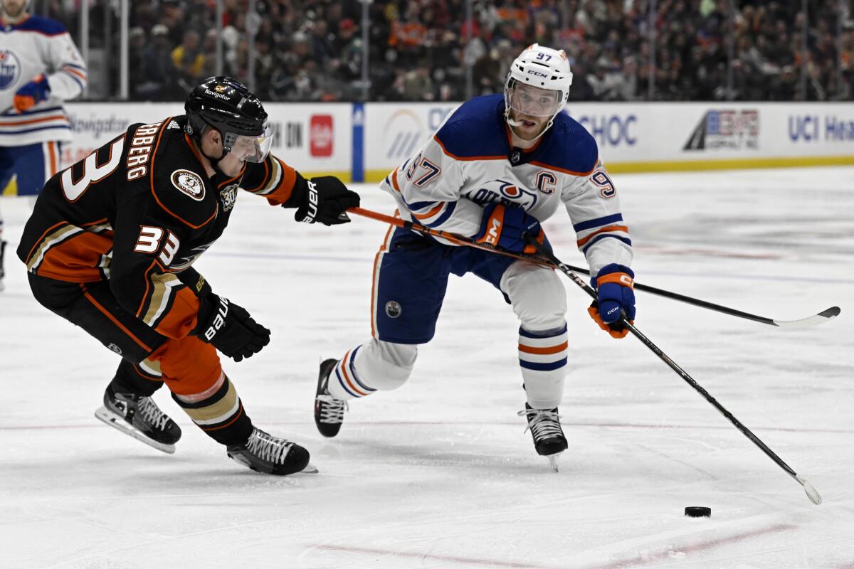 Edmonton Oilers center Connor McDavid controls the puck in front of Ducks right wing Jakob Silfverberg.