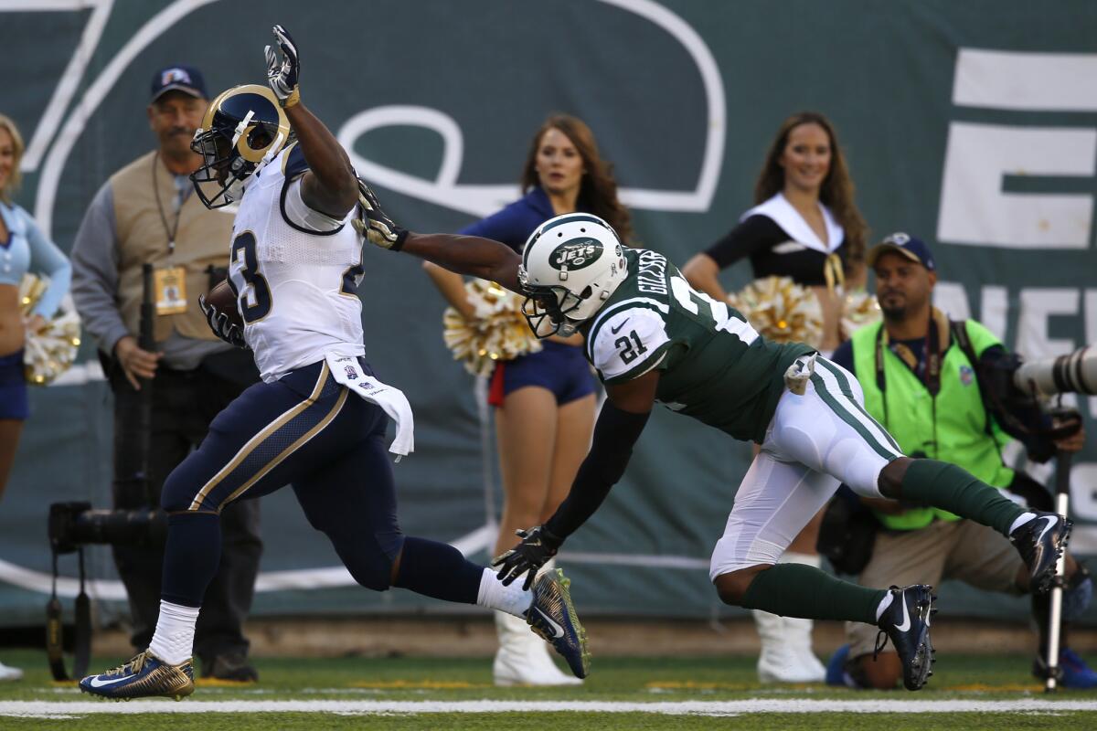 Rams running back Benny Cunningham is pushed out of bounds just short of the goal line by Jets safety Marcus Gilchrest during the first half Sunday.
