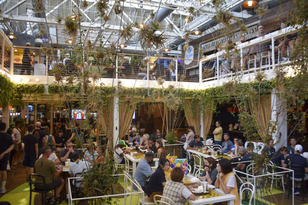 Customers eat at the Anaheim Packing House in July 2022.