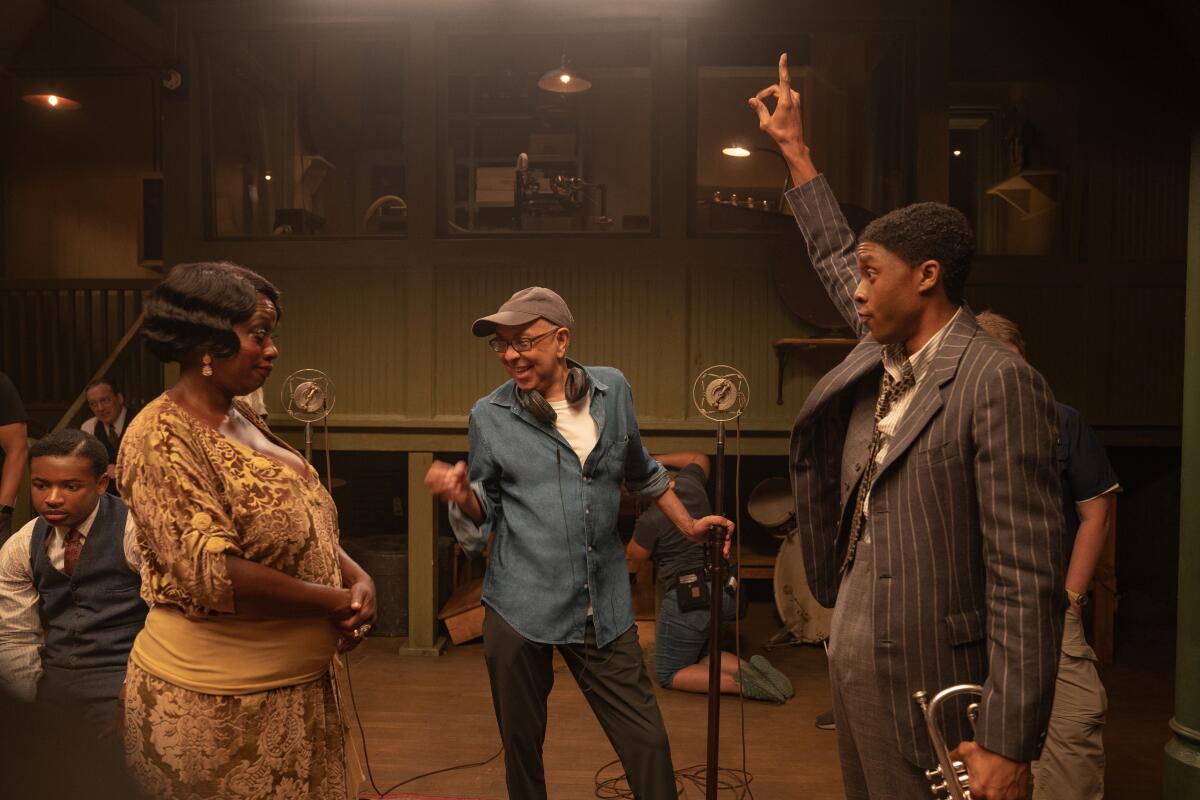 George C. Wolfe gestures between Viola Davis and Chadwick Boseman.