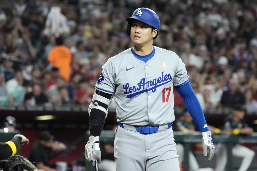 Los Angeles Dodgers designated hitter Shohei Ohtani, of Japan, walks back to the dugout after striking out against the Arizona Diamondbacks during the third inning of a baseball game Sunday, Sept. 1, 2024, in Phoenix. (AP Photo/Ross D. Franklin)