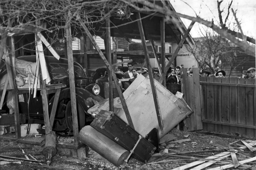 Raymond's damaged by the explosion. Doors were blown off the garage and the car's hood blown through the roof.