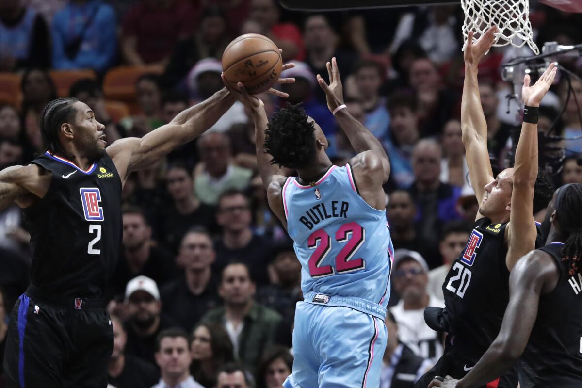 The Clippers' Kawhi Leonard, left, and Landry Shamet, right, defend the Heat's Jimmy Butler on Jan. 24, 2020, at AmericanAirlines Arena.